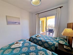a hotel room with two beds and a balcony at Riviera Relax & Pool in Mijas Costa +31 photos