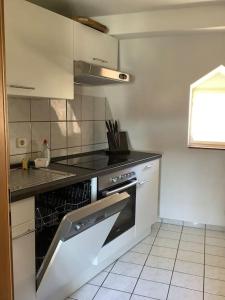 a kitchen with an oven and a counter top at Ferienwohnung im Schloss Obersontheim in Obersontheim