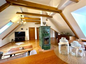 a living room with a wooden table and a fireplace at Historický dům u lázní in Třeboň