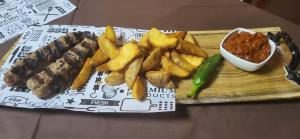 a plate of food with meat and french fries at Hotel Genesis in Vratsa +42 photos