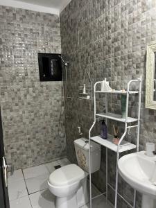a bathroom with a toilet and a sink at Élégance appart Ngor 4eme étage- plage à 500m in Ngor +32 photos