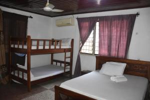 een slaapkamer met twee stapelbedden en een raam bij Kituri Hostel in Dar es Salaam
