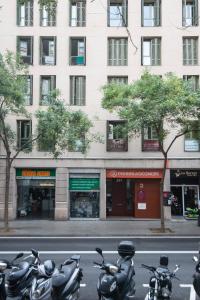 a group of motorcycles parked in front of a building at Pierre & Vacances Barcelona Sants in Barcelona
