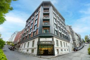 a tall building on a city street with cars parked at Icon Hotel Bomonti in Istanbul