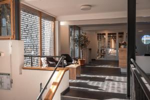 a hallway of a building with stairs and a door at Hotel am Schlossberg in Herrenberg