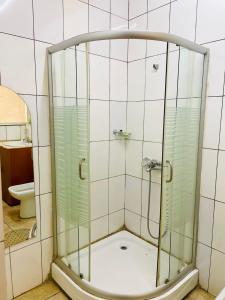a shower with a glass door in a bathroom at Nyagatare Diplomat Hotel in Nyagatare