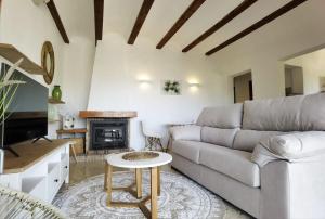 a living room with a couch and a table at Casa Agave in Denia