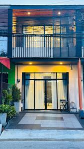 a house with a balcony and a patio at Chani House Hatyai in Hat Yai