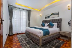 a bedroom with a large bed in a room at Tranquil Residence by Seluveto Homes in Nairobi