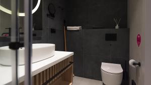 a bathroom with a white sink and a toilet at VacationClub - Baltic Waves Resort Apartament A118 in Międzyzdroje +17 photos