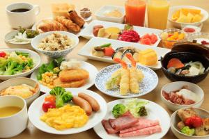 a table with many plates of food on it at Keisei Richmond Hotel Tokyo Monzennakacho in Tokyo