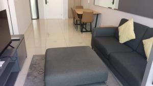 a living room with a couch and a table at The Robertson Bukit Bintang by Wowhome in Kuala Lumpur
