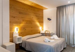 Postel nebo postele na pokoji v ubytování Hotel Degli Olmi