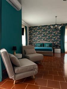 a living room with a couch and a chair at Palm House in Lamezia Terme