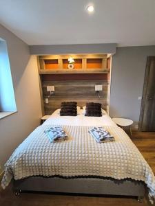 a bedroom with a bed with two pillows on it at Grand Studio Place Morny refait à neuf in Deauville