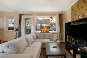 a living room with a couch and a tv at Kompass Oase in Burg