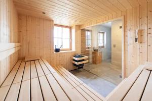 a large room with a glass door in a building at Chalet Tannenhaus I in Maltaberg +23 photos