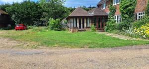 a house with a red car parked in front of it at Hale Oaks Farm in Rudgwick
