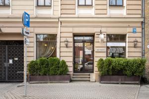 a building with a parking sign in front of it at Gertrude Hotel self check-in in Riga +46 photos
