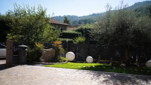 a garden with a fence and some trees and plants at Casa Catone (affitta camere) in Monte Porzio Catone
