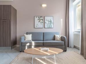 a living room with a couch and a coffee table at Limehome Verona La Vigna in Città in Verona +42 photos