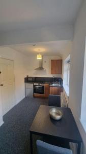 a kitchen with a table with a bowl on it at Studio Flat in Nottingham