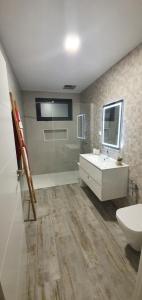 a bathroom with a sink and a tub and a toilet at Sea&Sunrise Village in Caniço +33 photos