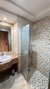 a bathroom with a shower and a sink at Sama Al Amany Hotel in Makkah