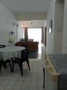 a living room with a table and a couch at Homestay PD LESTARI 2 in Port Dickson