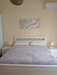 a bedroom with a large bed with two night stands at Nucifora's House in Riposto