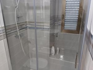 a bathroom with a shower with a glass door at A casa di Elena e Francesco in Bernalda +38 photos