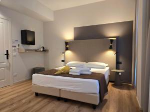 Postel nebo postele na pokoji v ubytování Hotel Porta Pia