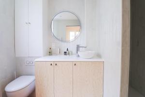 a bathroom with a sink and a mirror at Le Terracotta - T2 Design - Métro, RER & Jardin in Vincennes +12 photos