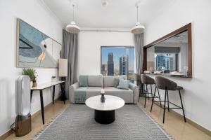 a living room with a couch and a table at Moderne 1BR with a lovely marina view in Dubai