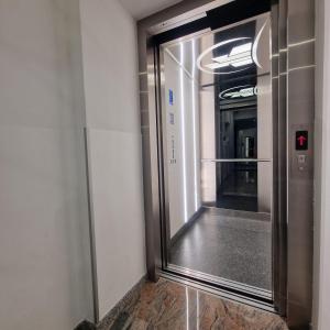 an elevator in a building with a glass door at Swiss Plus Hotel in Bihać +73 photos