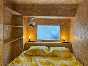 a bedroom with a bed with a tv on the wall at Studio Le Picardy, déco rétro in Le Crotoy