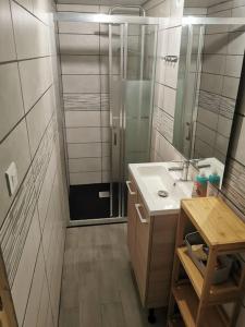 a bathroom with a sink and a shower at Petite maison de village charmante et authentique in Aniane