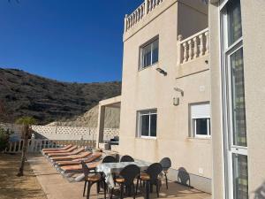 a group of tables and chairs next to a building at Villa Del Sol in Alicante