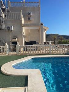 a swimming pool in front of a house at Villa Del Sol in Alicante