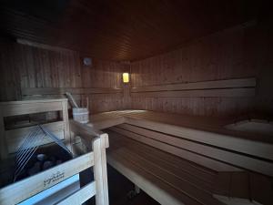 a wooden sauna with a tub and balls in it at Chalet Josi in Leutasch +25 photos