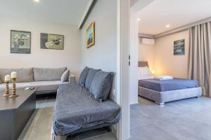 a living room with a couch and a bed at Starry Sky Luxury Apartment 2 in Lefkímmi