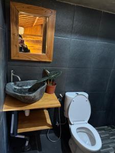 a bathroom with a sink and a toilet at Oemah Kangin Homestay in Amed