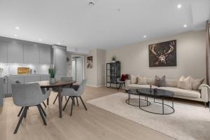 a living room with a couch and a table at Northstay - The Northview Retreat, Free Parking, Amazing Ocean Views in Tromsø