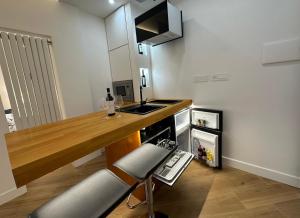 a kitchen with a wooden counter top and a sink at Exclusive tra mare e centro in Genova +13 photos