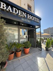 a hotel with potted plants outside of a building at Baden Hotel Suites in Amman