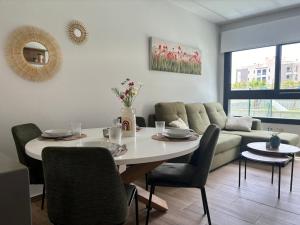 a living room with a table and a couch at Cosy Casa Valentino in Orihuela Costa