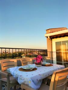 a table with plates and flowers on a balcony at The Rooftop Urla in Urla