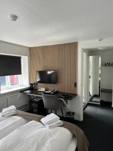 Postel nebo postele na pokoji v ubytování VISIONHOUSE Hotel