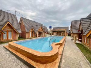 a swimming pool in front of some houses at Villa Andhita Pantai Garut in Mancagahar