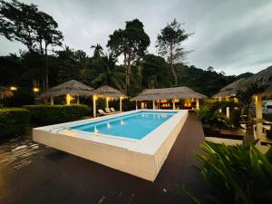 a swimming pool in front of a resort at Paradise Cottage in Ko Chang